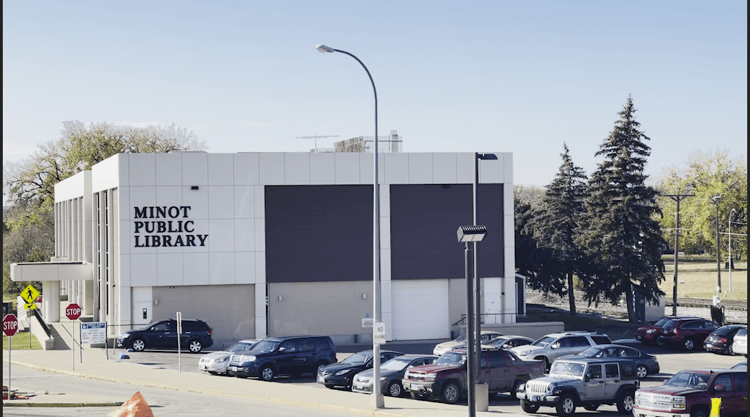 An image of the Minot Public Library from the east. A brick building with white accents